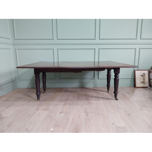 887 - Early 19th C. mahogany dining table raised on turned legs and brass castors {74 cm H x 194 cm W x 13... 