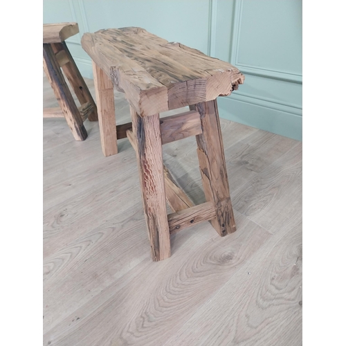 912 - Pair of vintage rustic oak stools raised on splayed legs {48 cm H x 61 cm W x 26 cm D}.