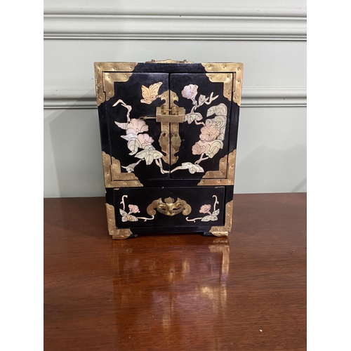 921 - Oriental ebonised and mother of pearl jewellery cabinet {24 cm H x 18 cm W x 15 cm D}.