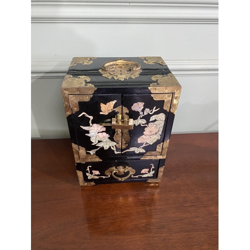 921 - Oriental ebonised and mother of pearl jewellery cabinet {24 cm H x 18 cm W x 15 cm D}.