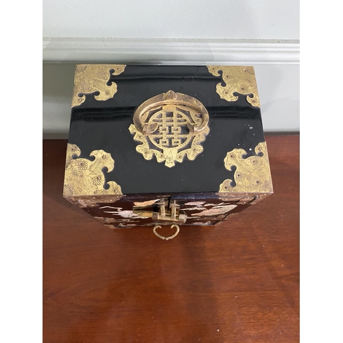 921 - Oriental ebonised and mother of pearl jewellery cabinet {24 cm H x 18 cm W x 15 cm D}.