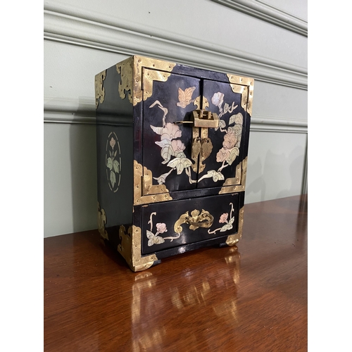 921 - Oriental ebonised and mother of pearl jewellery cabinet {24 cm H x 18 cm W x 15 cm D}.