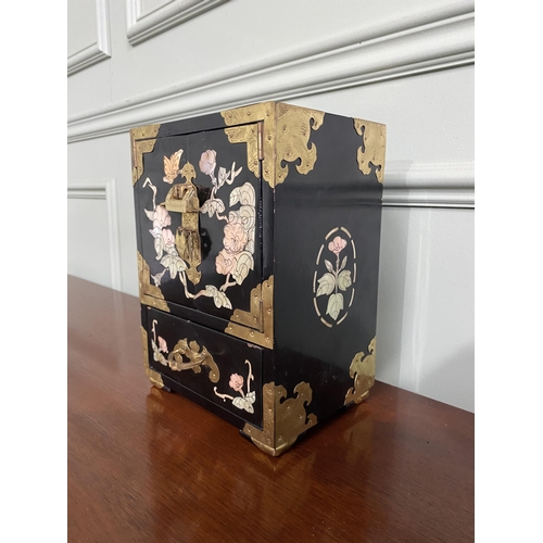 921 - Oriental ebonised and mother of pearl jewellery cabinet {24 cm H x 18 cm W x 15 cm D}.