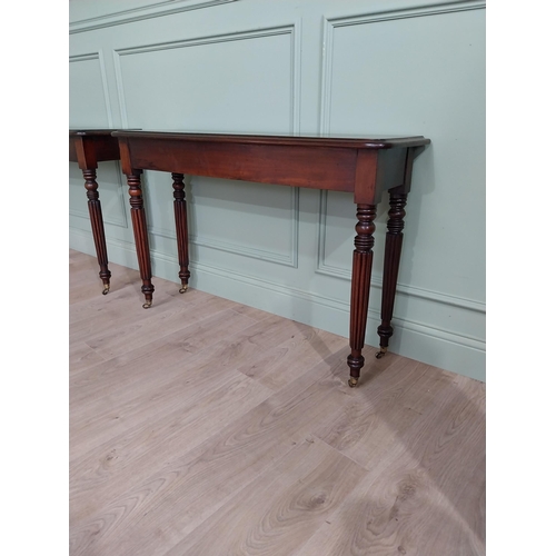 942 - Pair of good quality 19th C. mahogany side tables raised on reeded legs and brass castors {75 cm H x... 