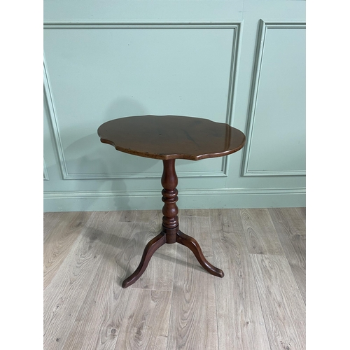 948 - Victorian mahogany shaped top wine table raised on turned column and three out swept legs {68 cm H x... 