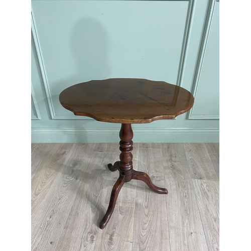 948 - Victorian mahogany shaped top wine table raised on turned column and three out swept legs {68 cm H x... 