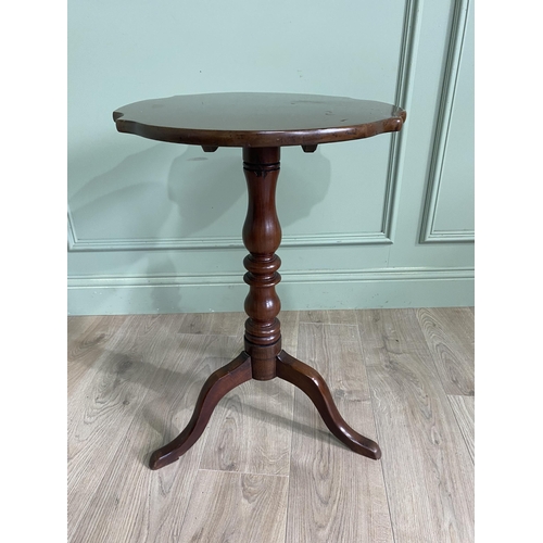 948 - Victorian mahogany shaped top wine table raised on turned column and three out swept legs {68 cm H x... 