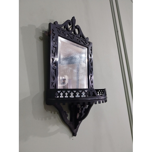 968 - Edwardian ebonised wall mirror with shelf {50 cm H x 24 cm W x 14 cm D}.