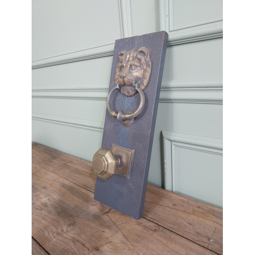 986 - Early 20th C. brass knocker and door pull mounted on pine plinth {44 cm H x 15 cm W x 10 cm D}.