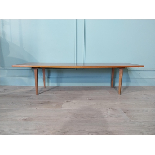 2035 - Mid Century teak coffee table on square tapered legs. {34 cm H x 138 cm W x 46 cm D}.