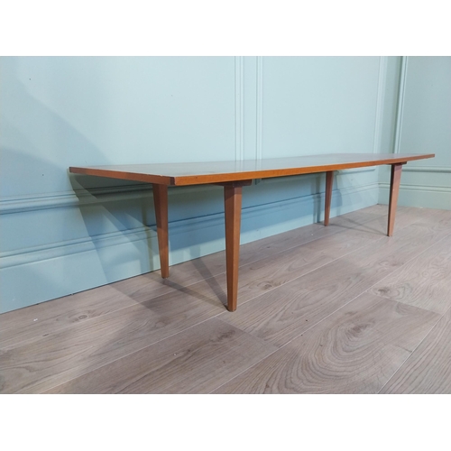 2035 - Mid Century teak coffee table on square tapered legs. {34 cm H x 138 cm W x 46 cm D}.