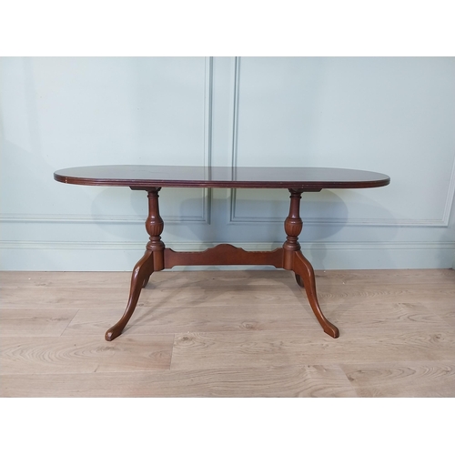 2054 - Mahogany coffee table, raised on turned supports and single stretcher. { 53cm H X 114cm W X 46cm D }... 