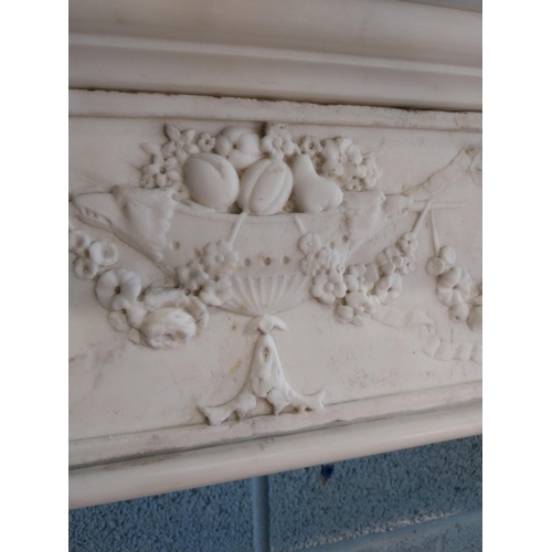 742 - Irish Georgian marble fire surround with central carved plaque depicting urns, rosettes, fruit and w... 