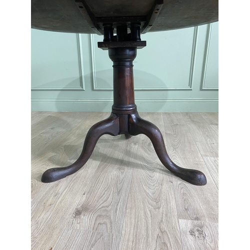 1117 - Irish Georgian mahogany tilt top super table raised on bird cage and gun barrel column and three out... 