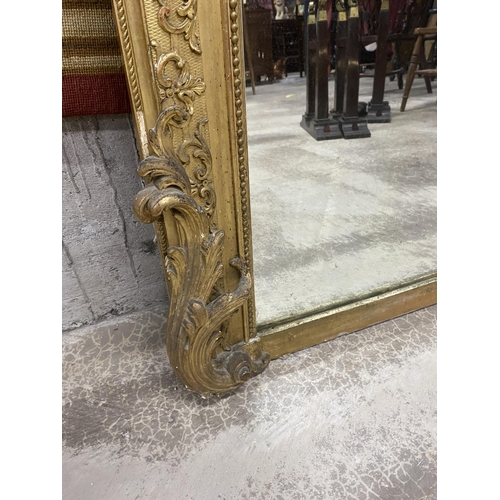 125 - 19th C. French decorative giltwood over mantle mirror {210 cm H x 143 cm W}.