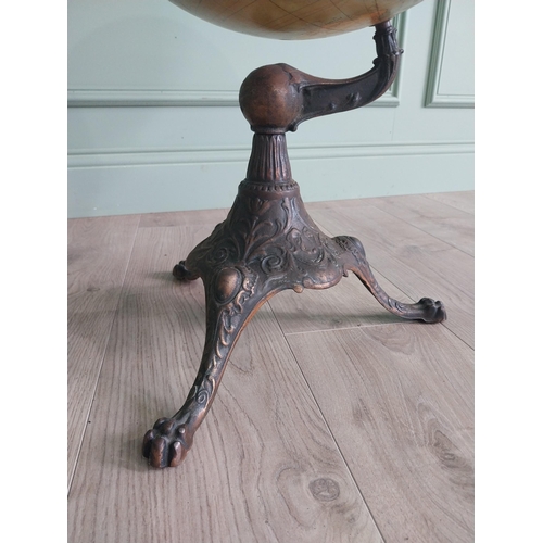 1252 - Early 20th C. world globe on decorative cast iron stand {72 cm H x 40 cm Dia.}.