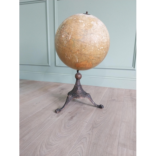 1252 - Early 20th C. world globe on decorative cast iron stand {72 cm H x 40 cm Dia.}.