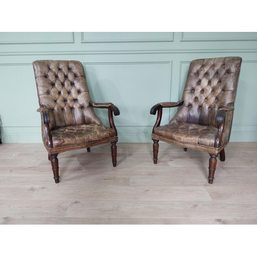 1320 - Pair of good quality deep buttoned leather upholstered library chairs on turned tapered legs. {108 c... 