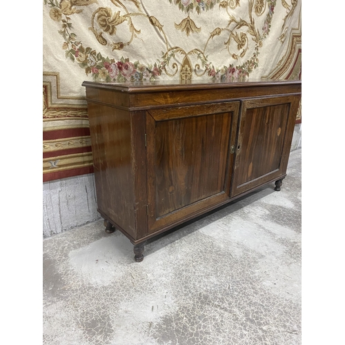 565 - 19th C. rosewood two door side cabinet raised on turned feet {86 cm H x 144 cm W x 44 cm D}.