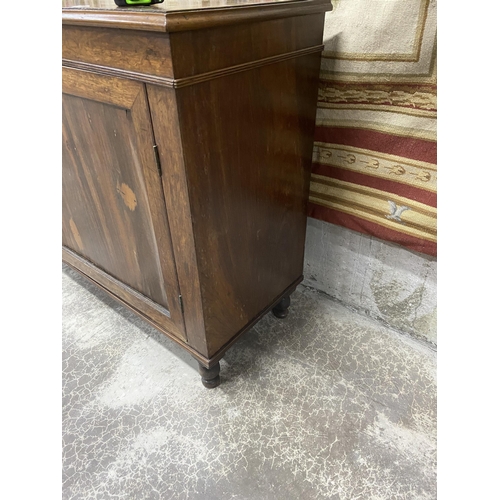 565 - 19th C. rosewood two door side cabinet raised on turned feet {86 cm H x 144 cm W x 44 cm D}.