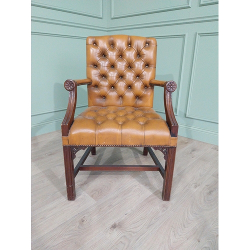 1375 - Mahogany deep buttoned leather upholstered Gainsborough armchair with upholstered arms terminating i... 