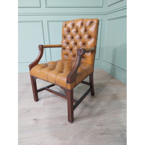 1375 - Mahogany deep buttoned leather upholstered Gainsborough armchair with upholstered arms terminating i... 