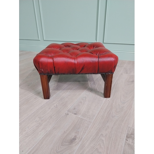 1325 - Ox-blood leather deep buttoned upholstered foot stool raised on square mahogany legs and single stre... 