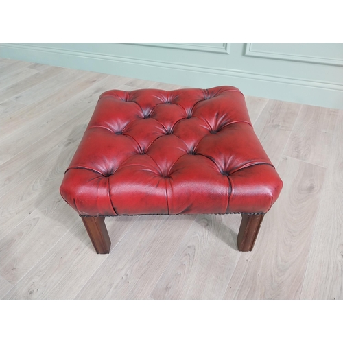 1325 - Ox-blood leather deep buttoned upholstered foot stool raised on square mahogany legs and single stre... 