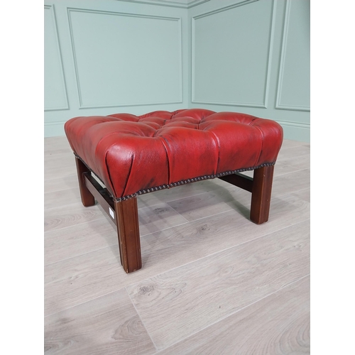 1325 - Ox-blood leather deep buttoned upholstered foot stool raised on square mahogany legs and single stre... 