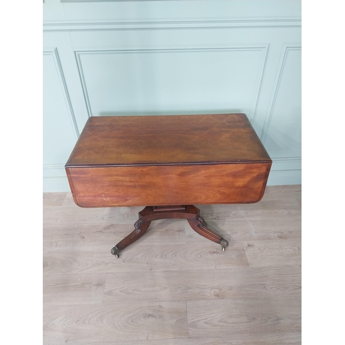 2086 - 19th C. drop leaf centre table with four outswept legs, brass lions paw feet and castors {72 cm H x ... 