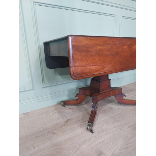 2086 - 19th C. drop leaf centre table with four outswept legs, brass lions paw feet and castors {72 cm H x ... 