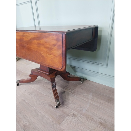 2086 - 19th C. drop leaf centre table with four outswept legs, brass lions paw feet and castors {72 cm H x ... 