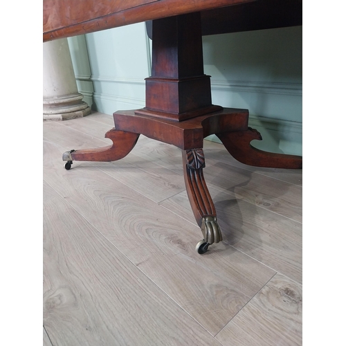 2086 - 19th C. drop leaf centre table with four outswept legs, brass lions paw feet and castors {72 cm H x ... 