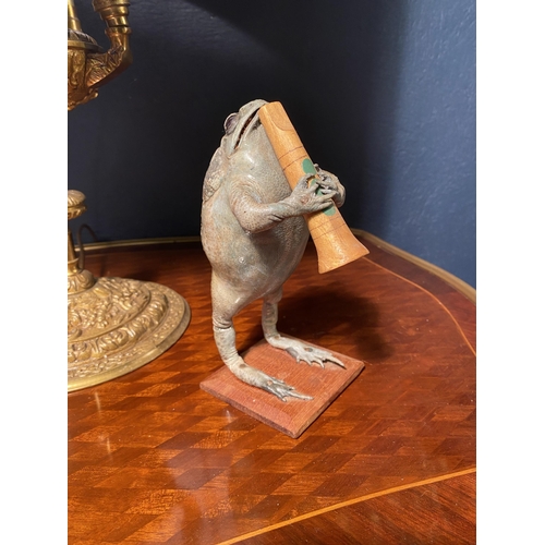 10 - Unusual model of a taxidermy Toad playing the clarinet {18cm  H  x 8cm W x 12cm D}.