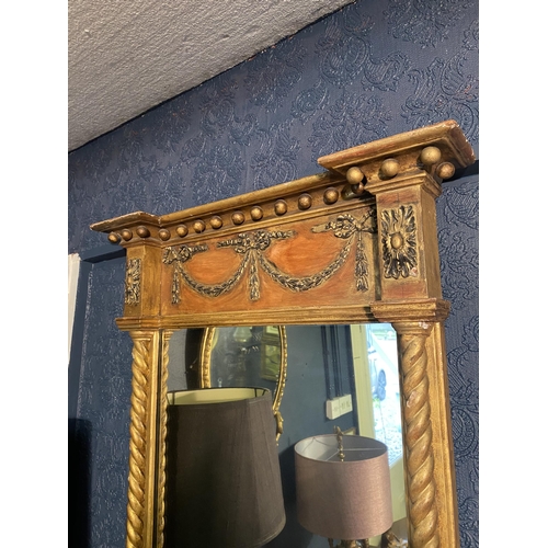 18 - Regency giltwood pier mirror decorated with swags flanked by barley twist columns {92cm  H  x 65cm W... 