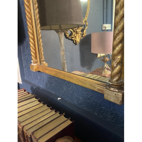 18 - Regency giltwood pier mirror decorated with swags flanked by barley twist columns {92cm  H  x 65cm W... 