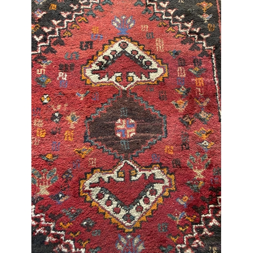 22 - Decorative Persian rug {121 cm L x 85 cm W}.