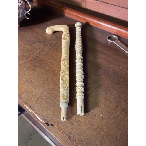 29 - Two 19th C. carved bone umbrella stick handles {24 cm L}.