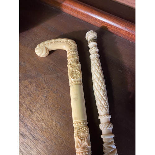 29 - Two 19th C. carved bone umbrella stick handles {24 cm L}.