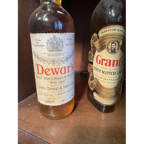 35 - Early 20th C. bottle of Dewar's Scotch Whiskey and bottle of Grants finest Scotch Whiskey.