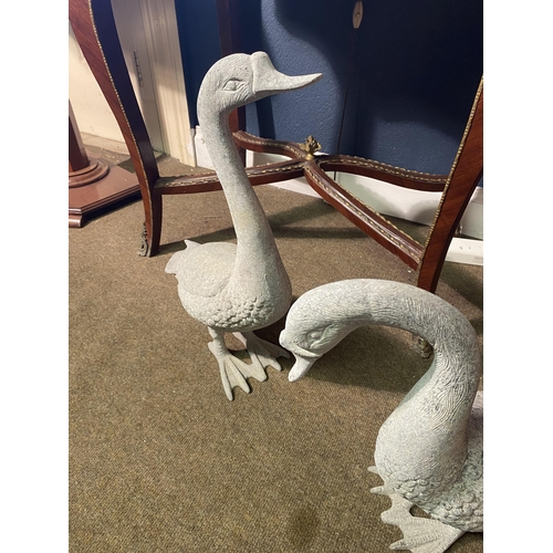 5 - Two cast alloy statues of Geese {53 cm H x 35 cm W x 16 cm D and 43 cm H x 48 cm W x 16 cm D}.