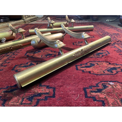 53 - Set of three brass wall picture lights {25cm  H  x 62cm W x 24cm D}.