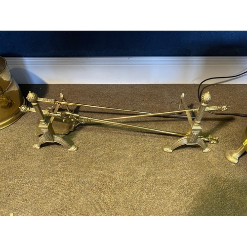 55 - Edwardian brass fire companion set and fire dogs {26cm  H  x 72cm W x 21cm D}.