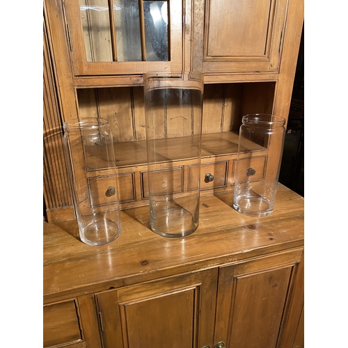 640 - Three glass flower vases {47 cm H, 35 cm H and 32 cm H}.