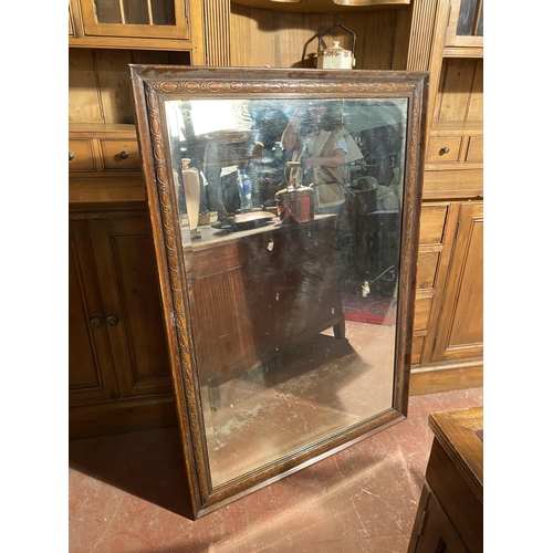 860 - Edwardian oak framed wall mirror {127cm  H  x 90cm W}.