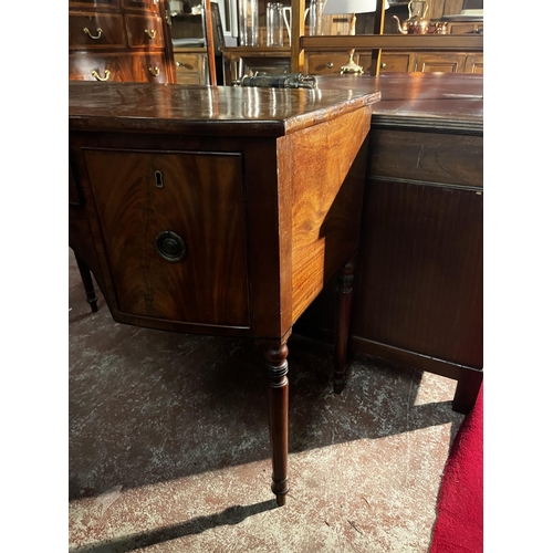 882 - Georgian bow fronted mahogany side board with three drawers in the frieze raised on turned legs of n... 