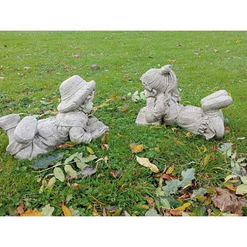 899 - Pair of composition stone figure boy and girl reading {H 32cm x W 25cm x D 47cm }.