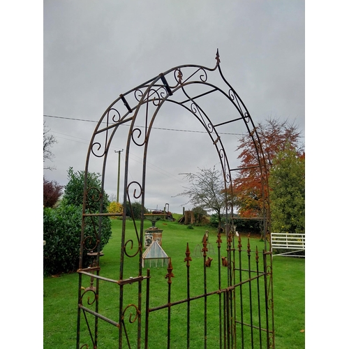 894A - Wrought iron rose arch with double gate {239 cm H x 133 cm W x 36 cm D}.