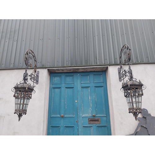 896A - Pair of decorative wrought iron wall hanging lights with brackets {205 cm H x 43 cm W x 100 cm D}.