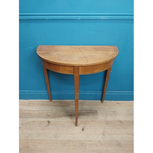 281 - Mahogany and satinwood demi lune table on three tapered feet. {74 cm H x 76 cm W x 41 cm}.